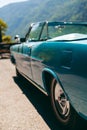 Color detail a vintage car sky blue color and shiny chrome, selective focus, turquoise, vertical photo