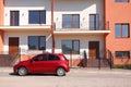 Color family car near modern buildings in city