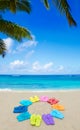 Color flip flops and drawing sun on sandy beach Royalty Free Stock Photo