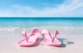 color flip-flops on white beach sand over blue transparent ocean Royalty Free Stock Photo