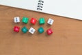 Color fraction dices, blank white notebook on wooden desk Royalty Free Stock Photo