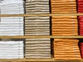 Color full stack of t-shirt in shopping mall or department store. Shelves with colorful T-shirts Royalty Free Stock Photo