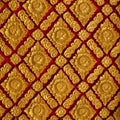 The color golden stucco on red and Thai art wall pattern Royalty Free Stock Photo