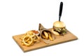 Big hamburger, steak fries and onion rings on a Royalty Free Stock Photo