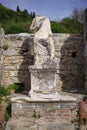 Ancient headless statue on a pedestal