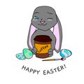 Color image of an Easter Bunny painting an egg and coffee