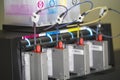 Color ink cartridges inside professional printing machine