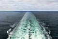 A color landscape photo of a cruise ship`s wake