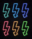 Color lightning bolt neon sign set on black wall. Royalty Free Stock Photo