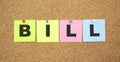 Color notes with letters pinned on a board. Word BILL. Royalty Free Stock Photo