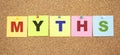 Color notes with letters pinned on a board. Word MYTHS. Royalty Free Stock Photo