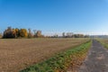 Autumnal rural countryside with fall foliage ,trees, fields, grass and a path Royalty Free Stock Photo