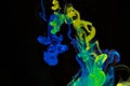 Color paint drops in water. Ink swirling underwater. Royalty Free Stock Photo