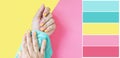 Color palette female hands in with a bright pink-yellow gradient manicure on a yellow-pink background. Royalty Free Stock Photo