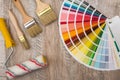 Color palette guide and paint brush roller  on wood board Royalty Free Stock Photo