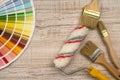 Color palette guide and paint brush roller  on wood board Royalty Free Stock Photo