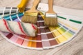 Color palette guide and paint brush roller on wood board