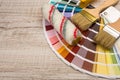 Color palette guide and paint brush roller  on wood board Royalty Free Stock Photo