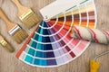 Color palette guide and paint brush roller  on wood board Royalty Free Stock Photo