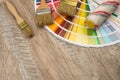 Color palette guide and paint brush roller  on wood board Royalty Free Stock Photo