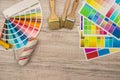 Color palette guide and paint brush roller  on wood board Royalty Free Stock Photo