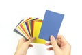Color palette samples in hand on white background. Rainbow sample colors catalogue