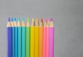 Color pancils with grey background, Group of colorful pencils laying in row striaght line made by pencil tips close up, copy Royalty Free Stock Photo