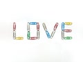 Color paperclips to love on white background