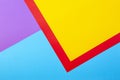 Color papers geometry flat composition background with yellow red violet and blue tones