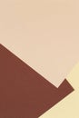 Color papers geometry vertical composition background with yellow beige and brown tones. Neutral earth colored