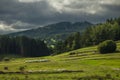 Color pasture lands and meadows in north Austria with dark stormy sky