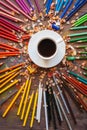 Color pencil and a cup of coffee on wooden background Royalty Free Stock Photo