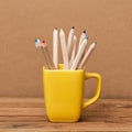 Color pencil in the cup on wooden background Royalty Free Stock Photo