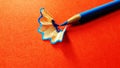 color pencil with its shave isolated on orange background Royalty Free Stock Photo