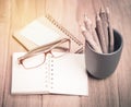 Color pencil made of branches with glasses and note book on wood Royalty Free Stock Photo