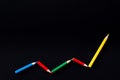 Color pencil in a pattern of a graph on black color background Royalty Free Stock Photo