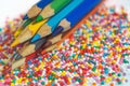 Color pencils on the background of texture multi-colored balls close-up. Set for children`s creativity and development