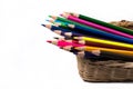 Color pencils in the basket, isolated on white background