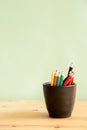 Color pencils in cup on wooden table Royalty Free Stock Photo