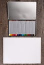 Color pencils in case and blank paper on wooden table Royalty Free Stock Photo