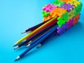 The color pencils in colorfull of pencil holder make form puzzle number on blue background. Concept of education. copy space for t
