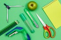 Color pencils, compass, stapler, felt-tip pen, paper knife, apple, scissors and notebook Royalty Free Stock Photo