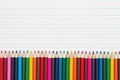 Color pencils crayons on vintage ruled line notebook paper Royalty Free Stock Photo