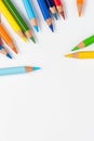 Color pencils for drawing scattered around on a white background. Royalty Free Stock Photo