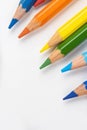 Color pencils for drawing scattered around on a white background. Royalty Free Stock Photo