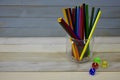 Color pencils glass jar colorful acrylic dice wooden rustic background