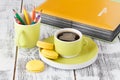 Color pencils in a green cup with greenish mug of coffee Royalty Free Stock Photo