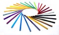 Color pencils isolated on the white background forming a circle. Rays of color pencils