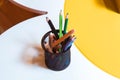 Crayons in a bowl . Color pencils for the drawing, located in a support as a vase . Multicolored pens