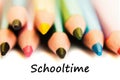 Color pencils isolated on white background. Text schooltime.